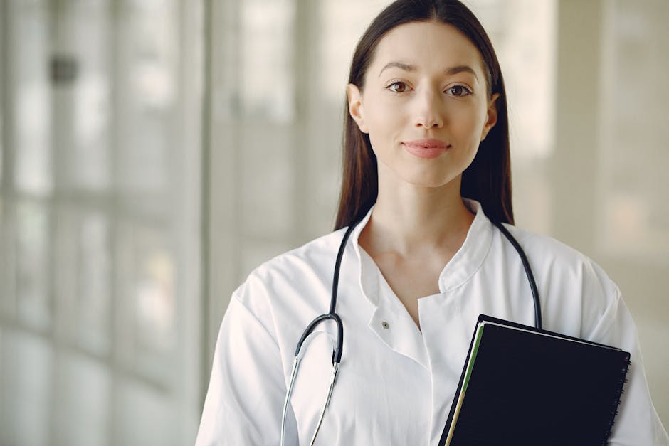 Smiling female doctor standing in modern medical room with panoramic window.