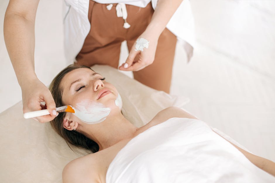 Woman receiving a rejuvenating facial treatment at a spa