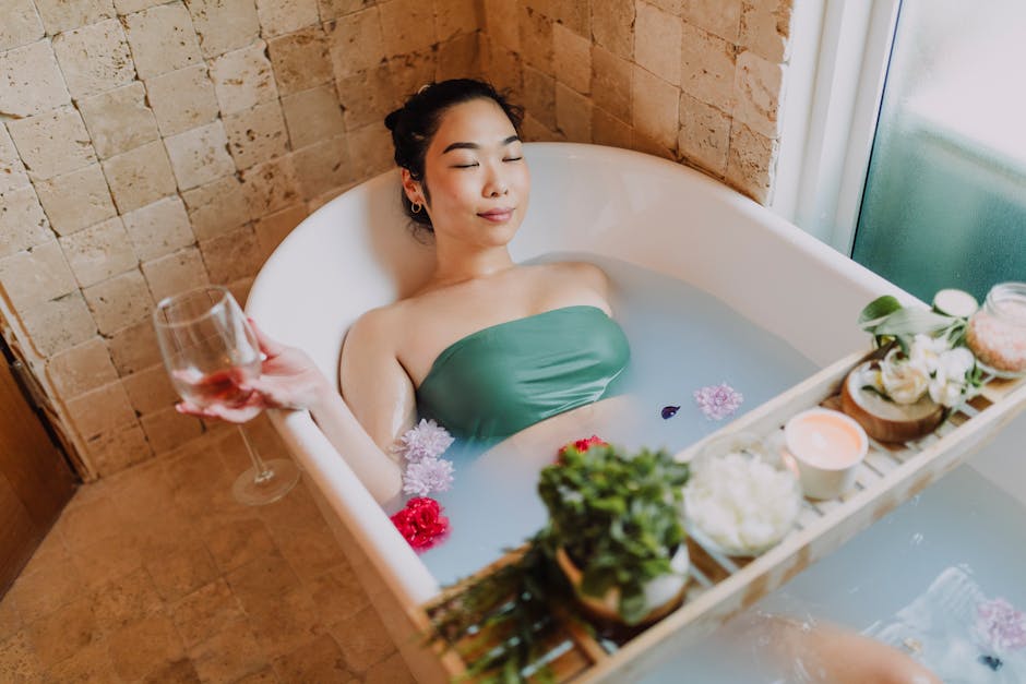 Asian woman enjoys a peaceful flower bath with wine