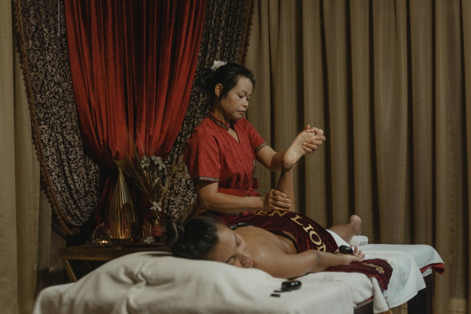 A woman receives a therapeutic massage from a professional masseuse