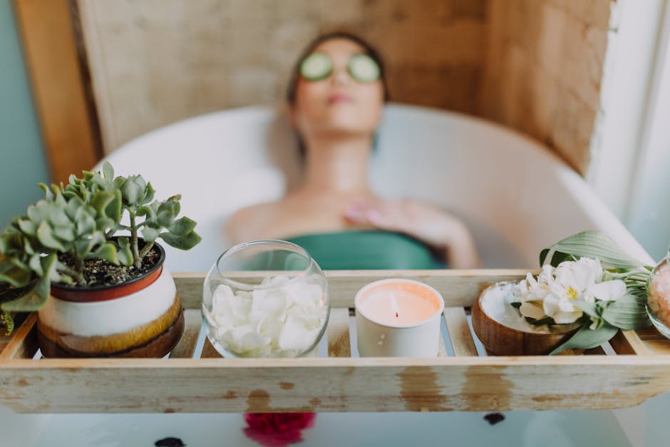 Woman relaxing in a bathtub with a candle and plants