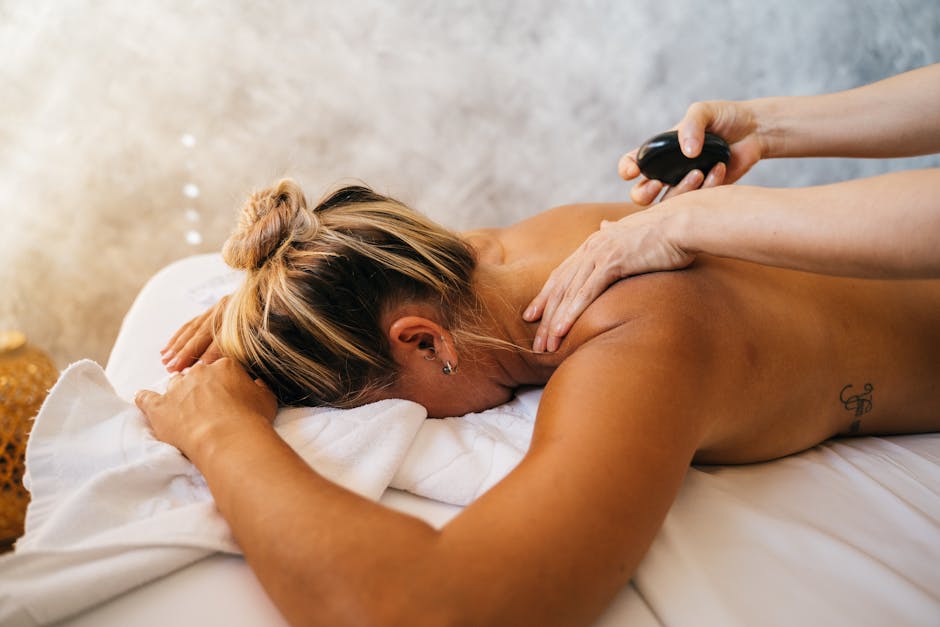 A woman enjoying a relaxing hot stone massage therapy