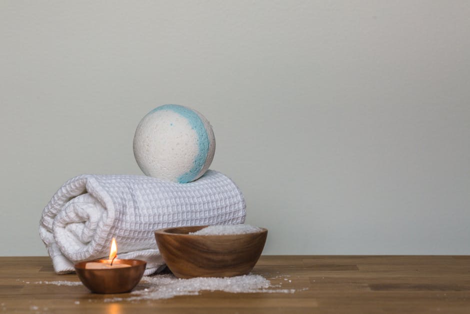 Peaceful spa setting with bath bomb, salt, candle, and towel